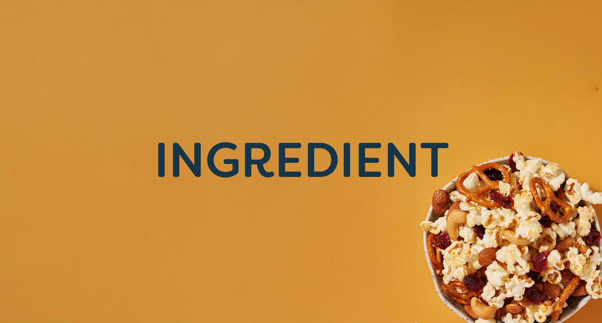 A bowl of trail mix sitting on a yellow background with "Ingredient" as a text overlay.