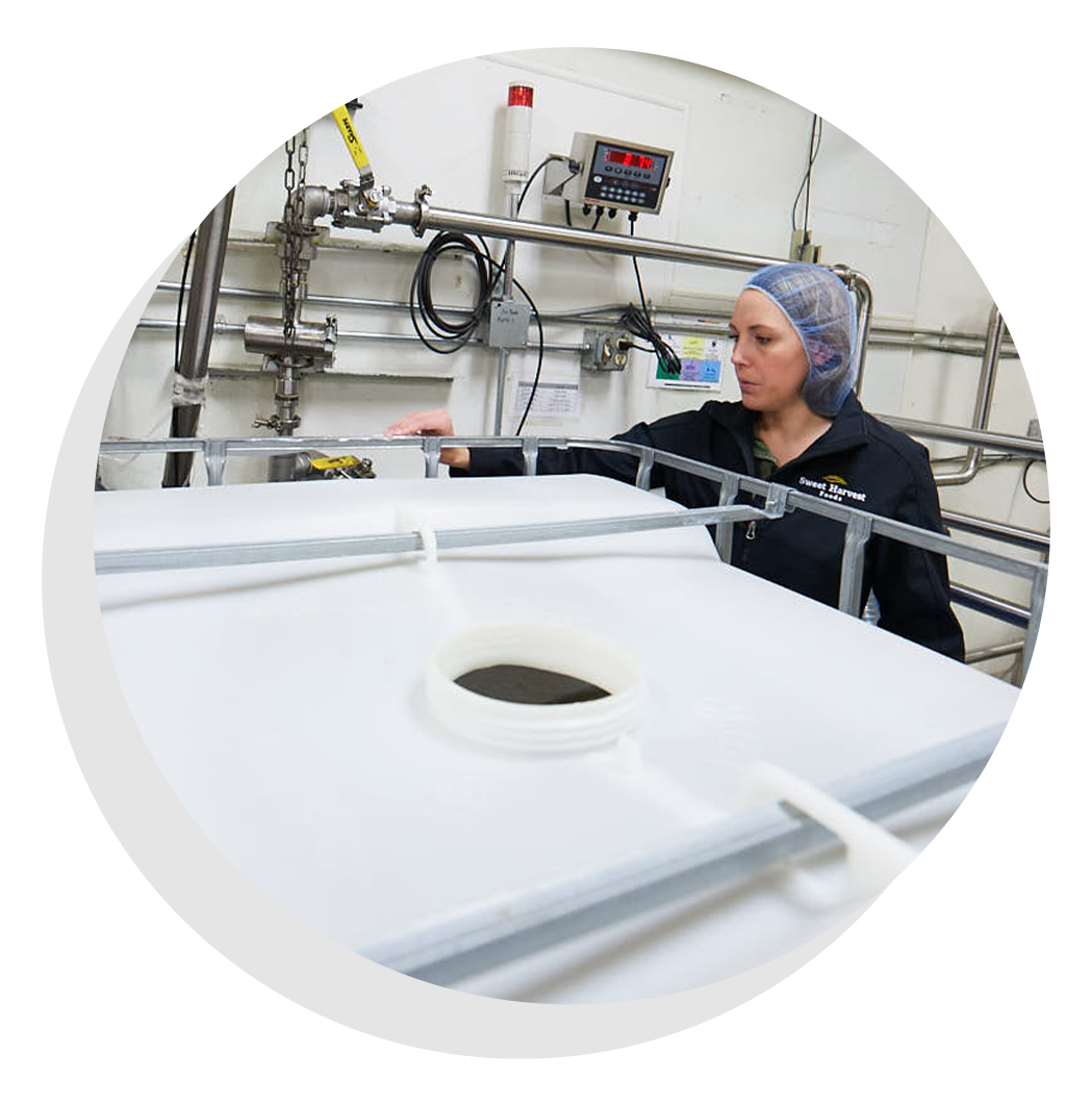 Worker wearing a hairnet in a food production facility.