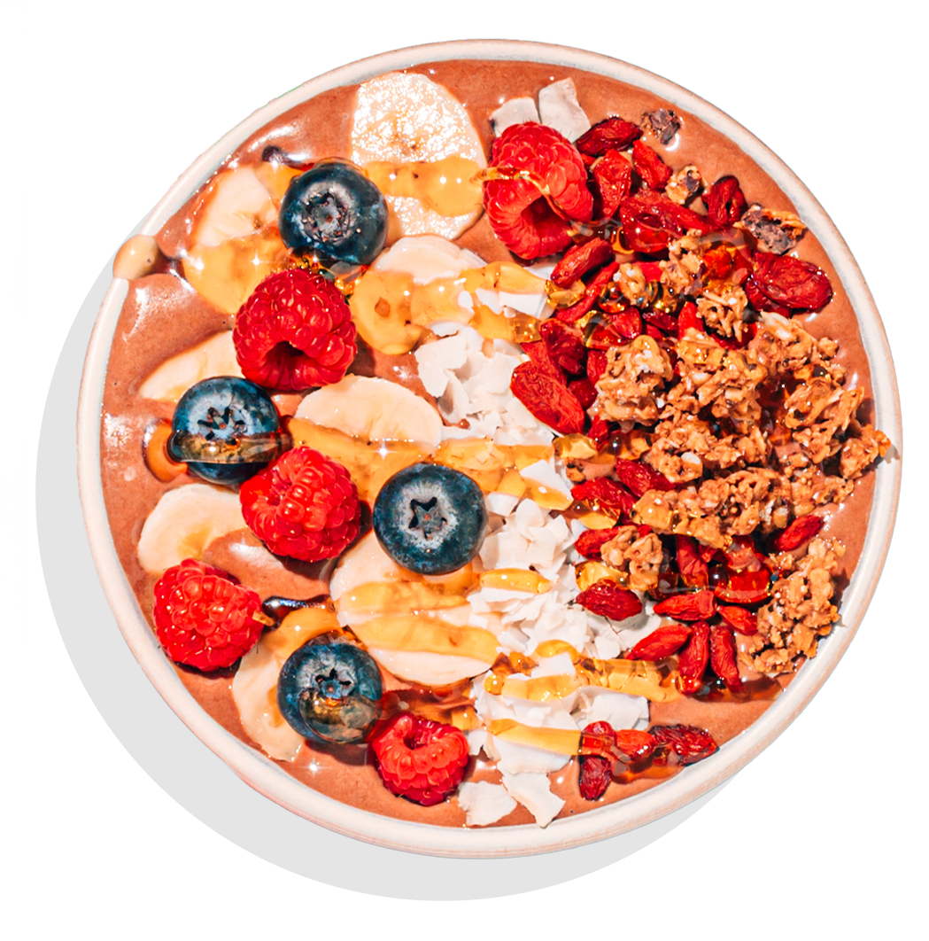 Smoothie bowl with blueberries, raspberries and a honey drizzle.