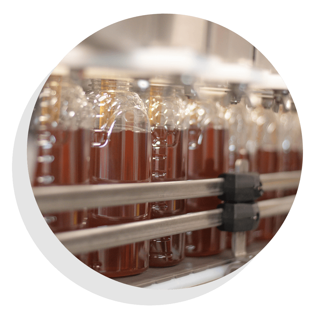 Honey bottles on an assembly line.