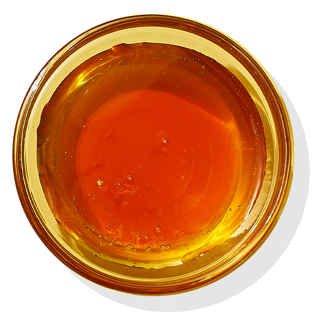 Bowl of honey in clear dish.