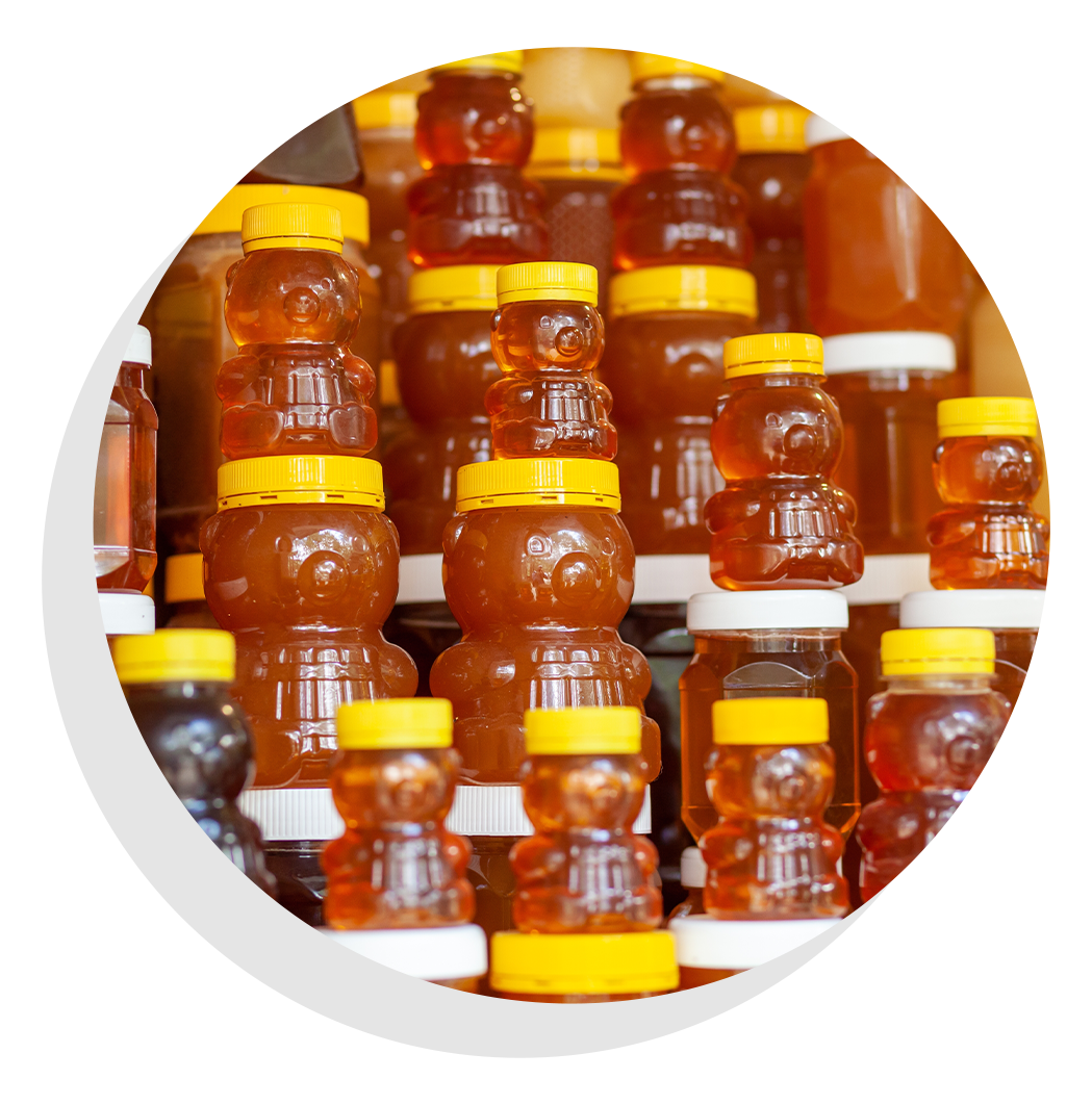 Honey bottles with carrying colors and containers.
