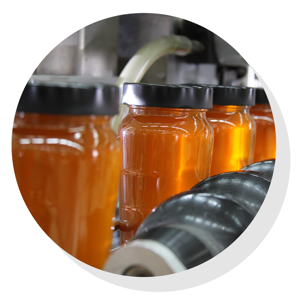 Jars of honey on assembly line.
