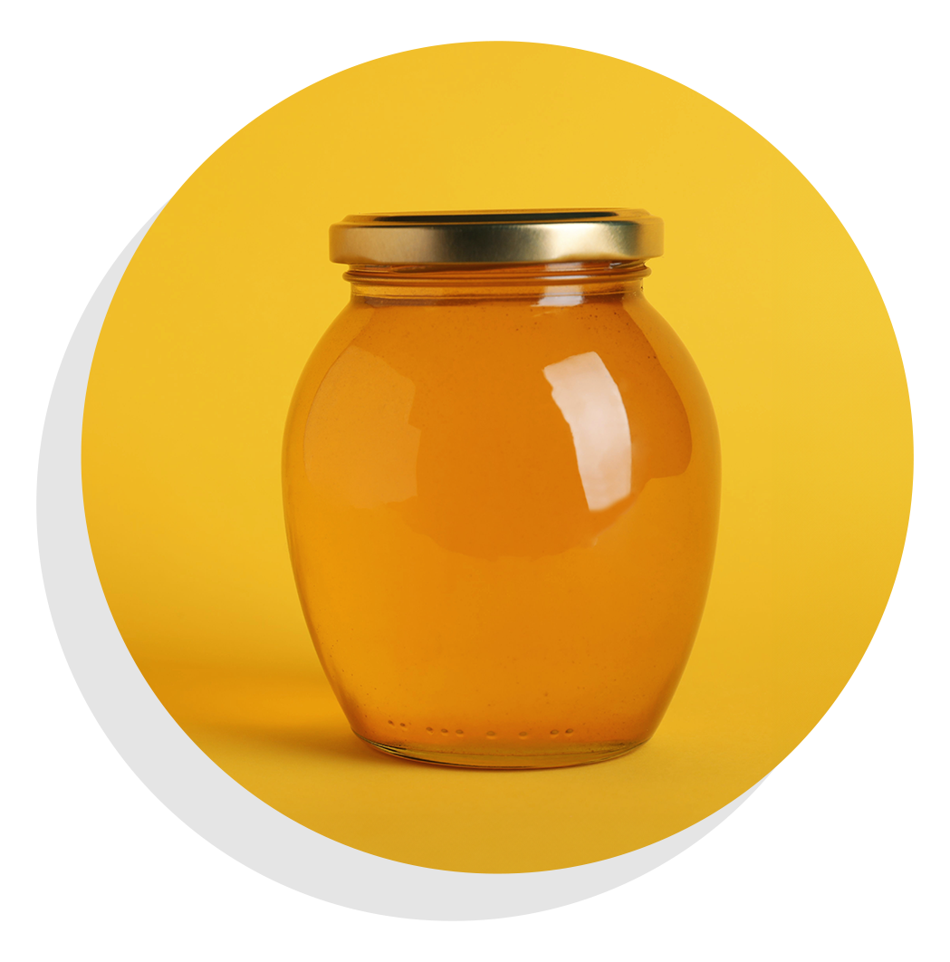 Jar of honey with yellow background.