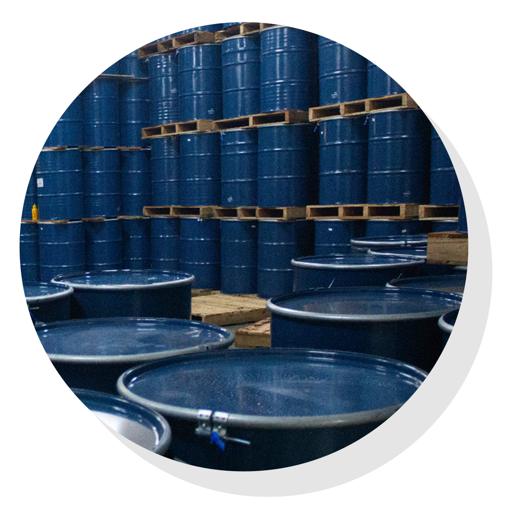 Stacked drums in warehouse.
