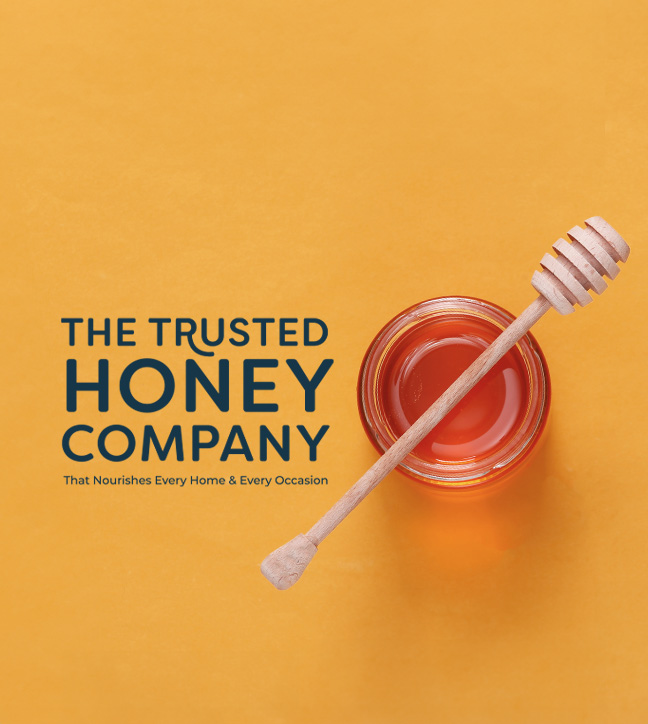 Banner with honey with wooden honey dipper on a yellow background with a "The Trusted Honey Company - The Nourishes Every Home & Every Occasion" text overlay.